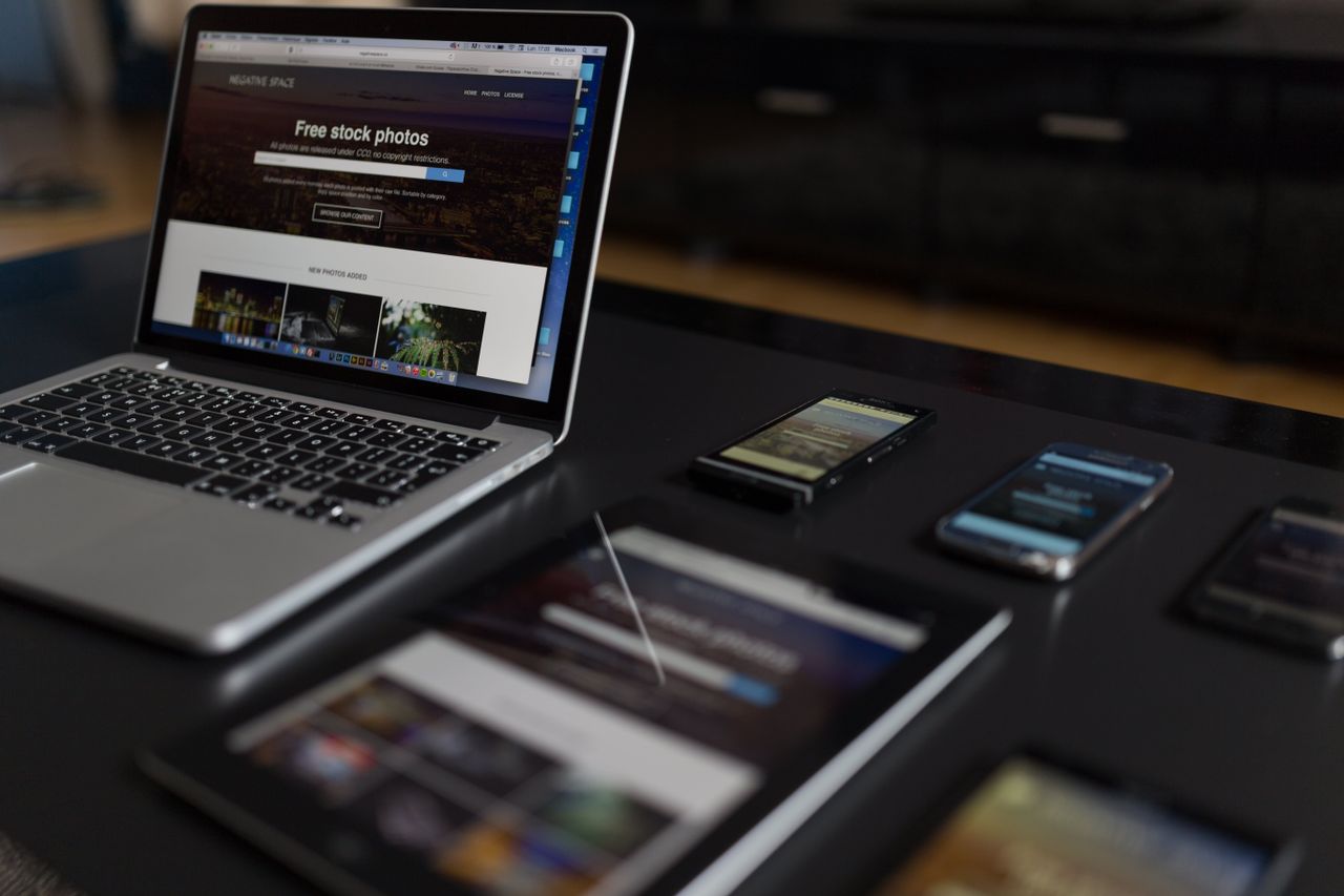Home A contemporary workspace showcasing a laptop, tablet, and smartphones, ideal for tech and freelance use.